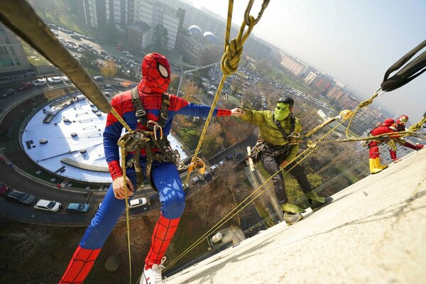 Acrobatic superheroes scale children's hospital to visit young patients