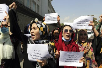 The Latest: Dozens march for women's rights at Kabul palace